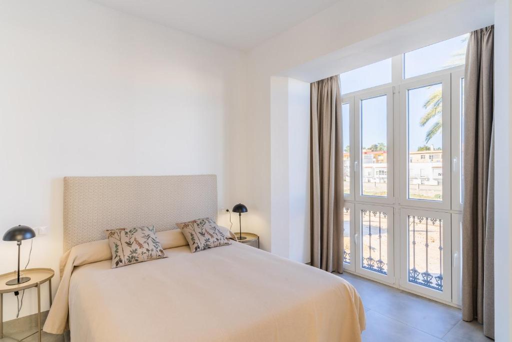 Posteľ alebo postele v izbe v ubytovaní CASA DE LA VEGA SUITES