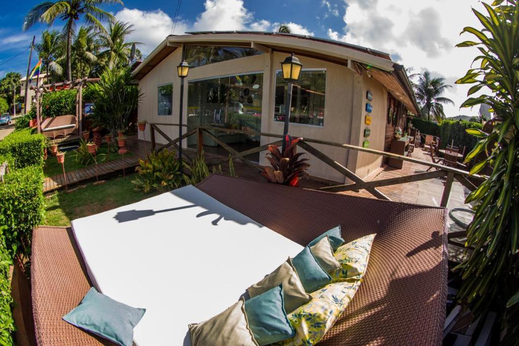 a couch sitting on a patio with a house at Pousada Fortaleza in Fernando de Noronha