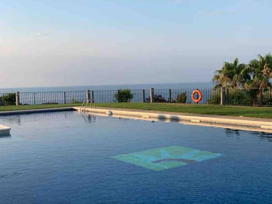 a swimming pool with the ocean in the background at Casa con impresionantes vistas al mar in Tossa de Mar
