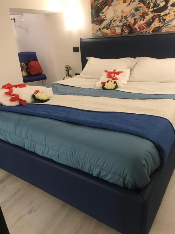 a bed with two stuffed animals sitting on it at La Suite sul Mare in Crotone