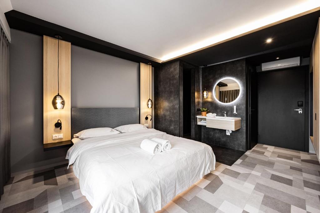 a bedroom with a large white bed and a sink at Phoenix7 in Mödling