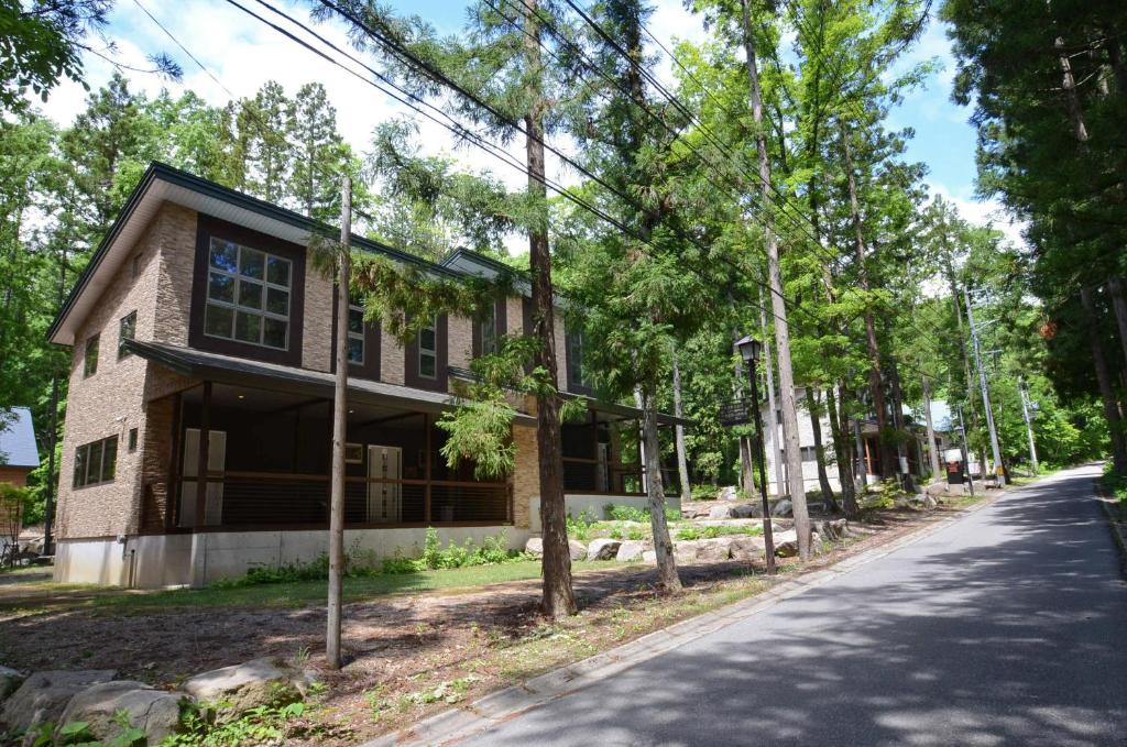 a house on the side of a road at Phoenix Chalets by HHG in Hakuba
