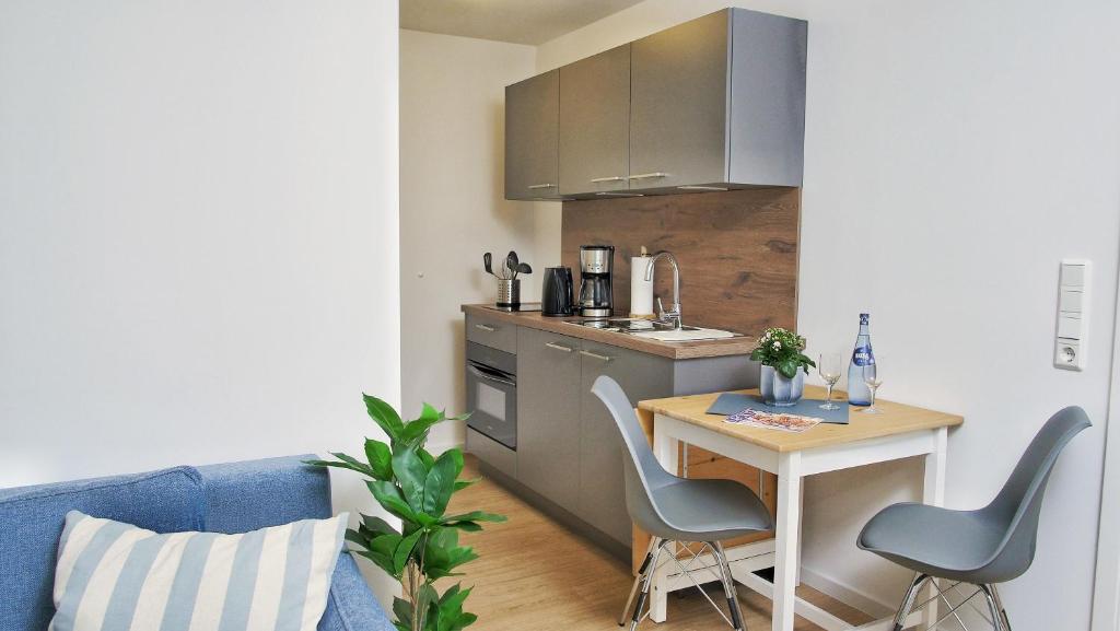 a small kitchen with a small table and chairs at Quartier1 in Zeven