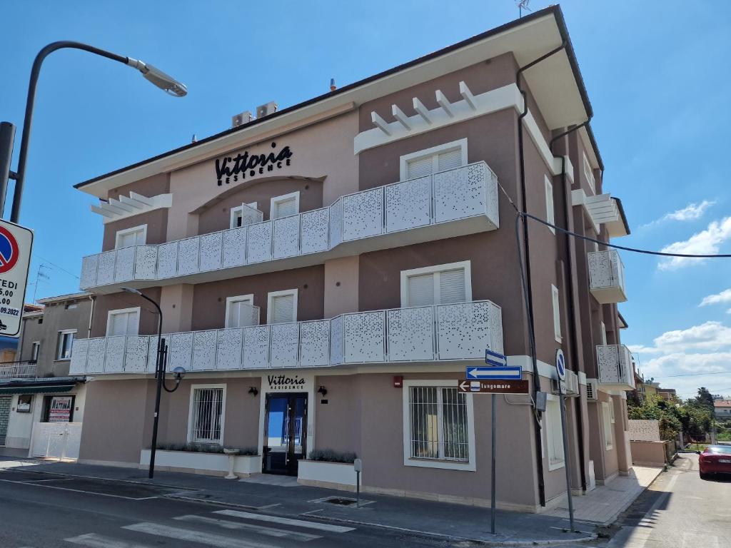 a building with a balcony on the side of it at Residence Vittoria in Alba Adriatica