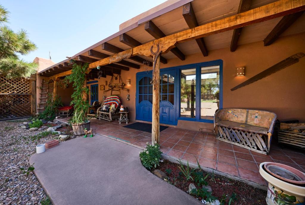 a house with a blue door and a patio at Loba Luna-Come Home To Enchantment in Albuquerque