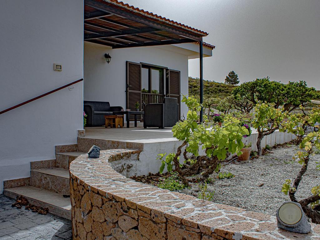 a house with a stone wall and a patio at Live Adeje Ifonche Relax Place with Terrace in Adeje