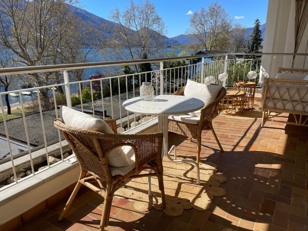 a patio with a table and chairs on a balcony at Minusio-Locarno Casa al Lago 1 in Minusio