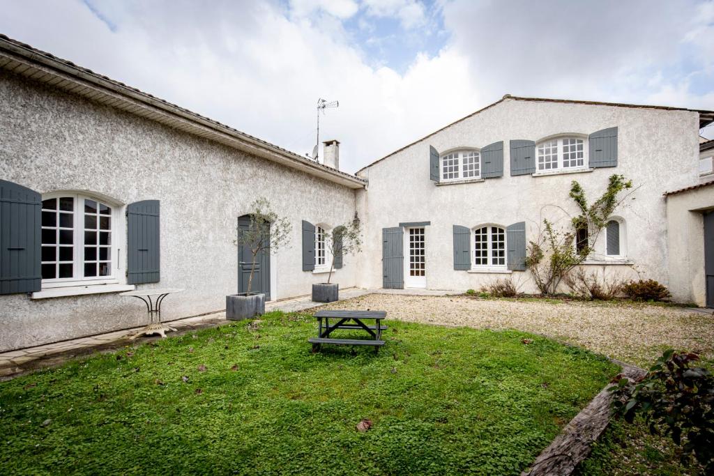 a house with a picnic table in the yard at Maison 5 chambres #8pers #Stationnement gratuit in Cognac