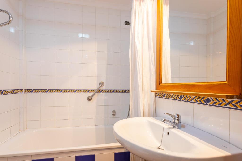 a bathroom with a sink and a bath tub at Apartamentos Solset Nerja in Nerja