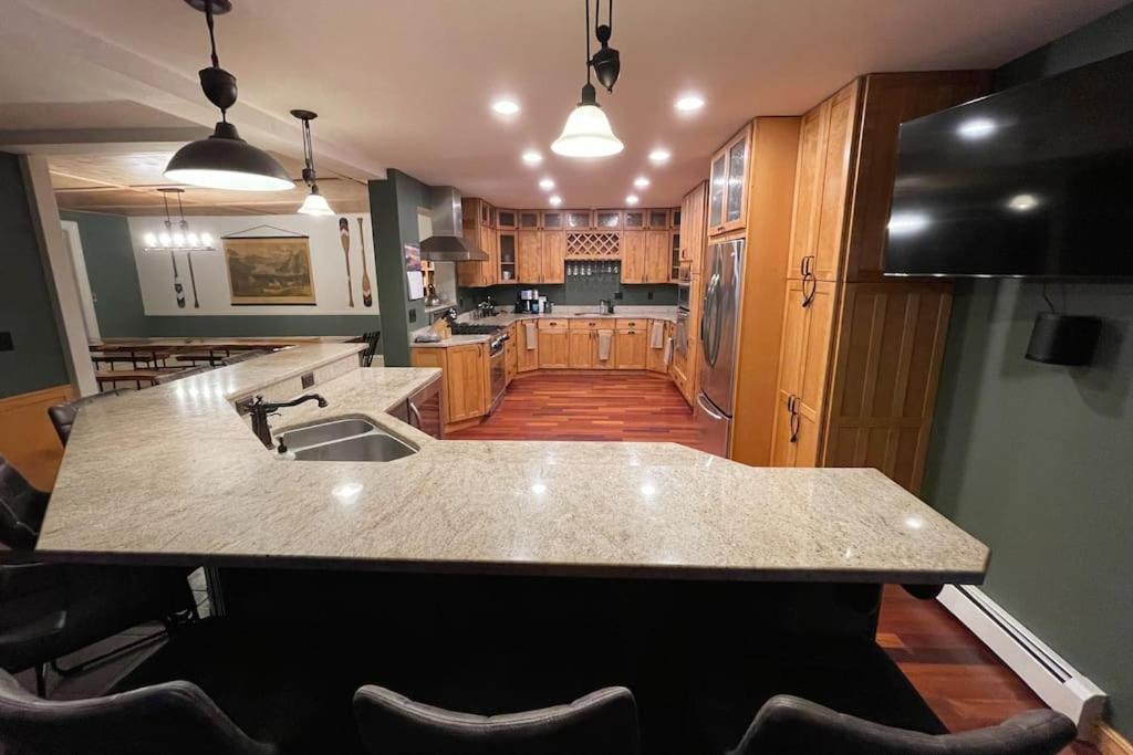 a kitchen with a sink and a counter top at ADK Game House in Au Sable Forks