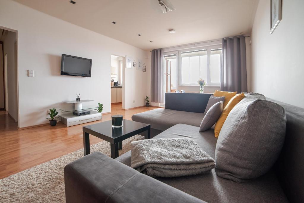a living room with a couch and a table at Strawberry Apartment in Bratislava