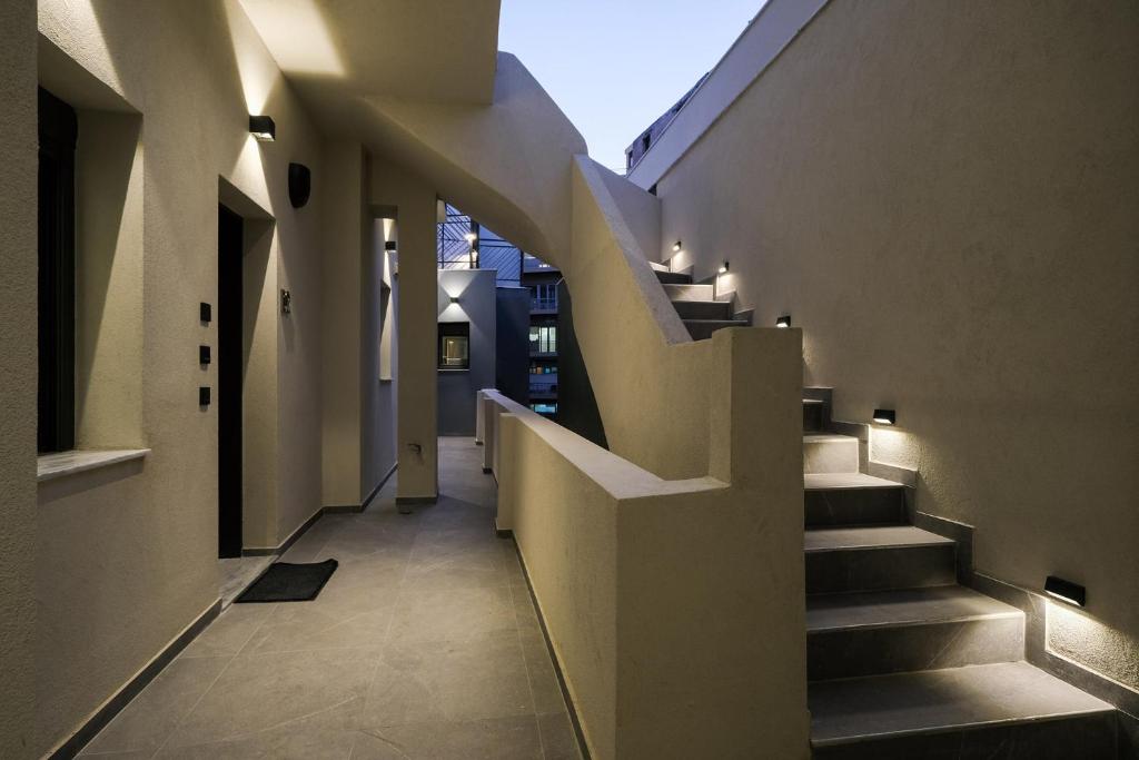 a hallway of a house with stairs and lights at Athenian Island Project in Athens