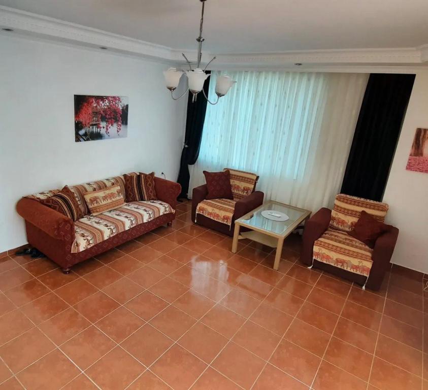 a living room with two couches and a table at Apartments in Eşme