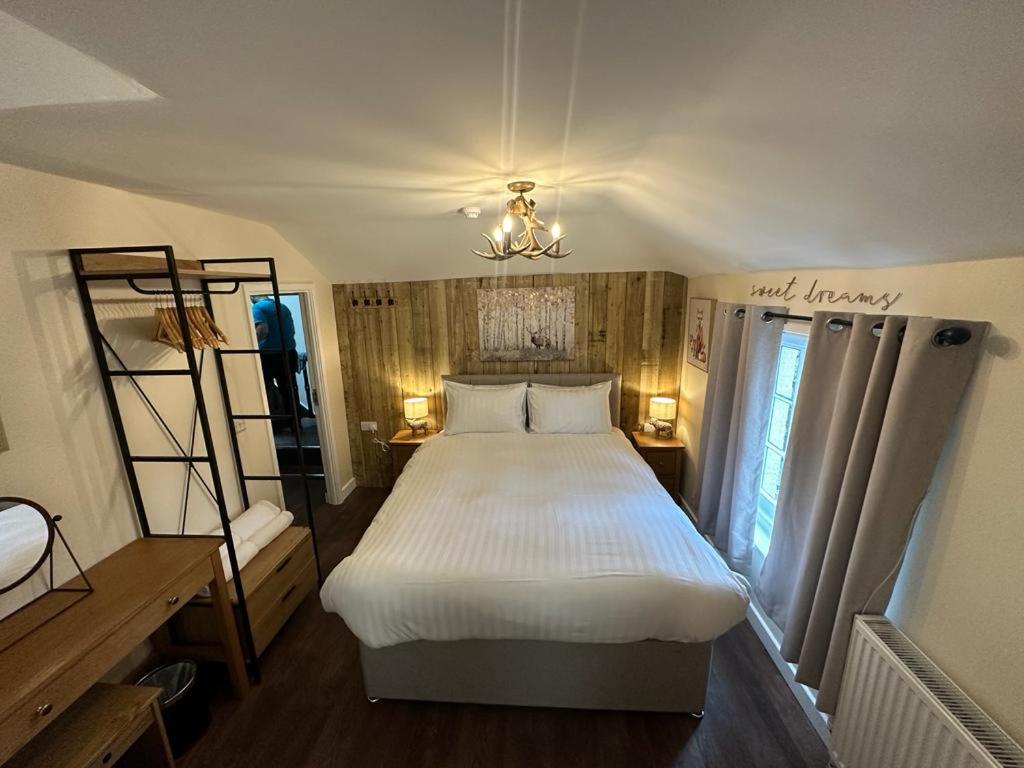 ein Schlafzimmer mit einem großen Bett in einem Zimmer in der Unterkunft The New Forest Inn in Lyndhurst
