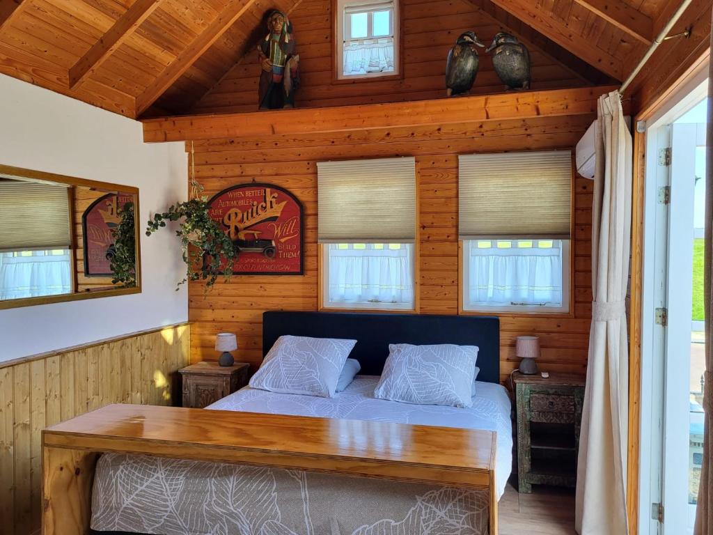 a bedroom with a bed in a wooden cabin at 't Maerhus in Hindeloopen