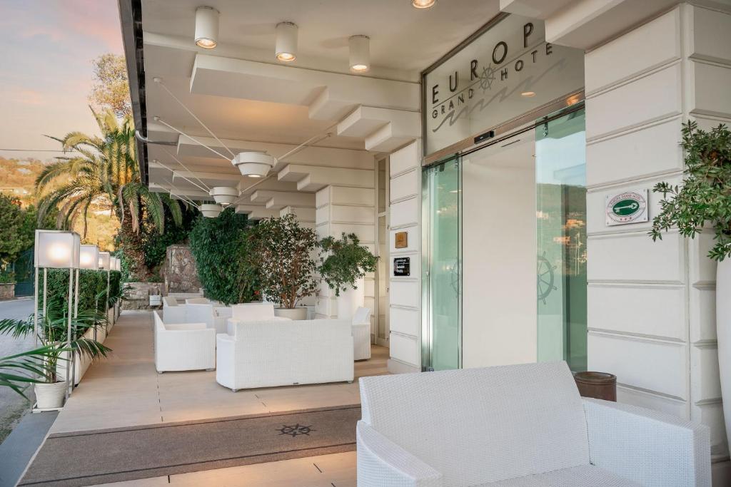 a store front with white chairs and plants at Europa Grand Hotel in Lerici