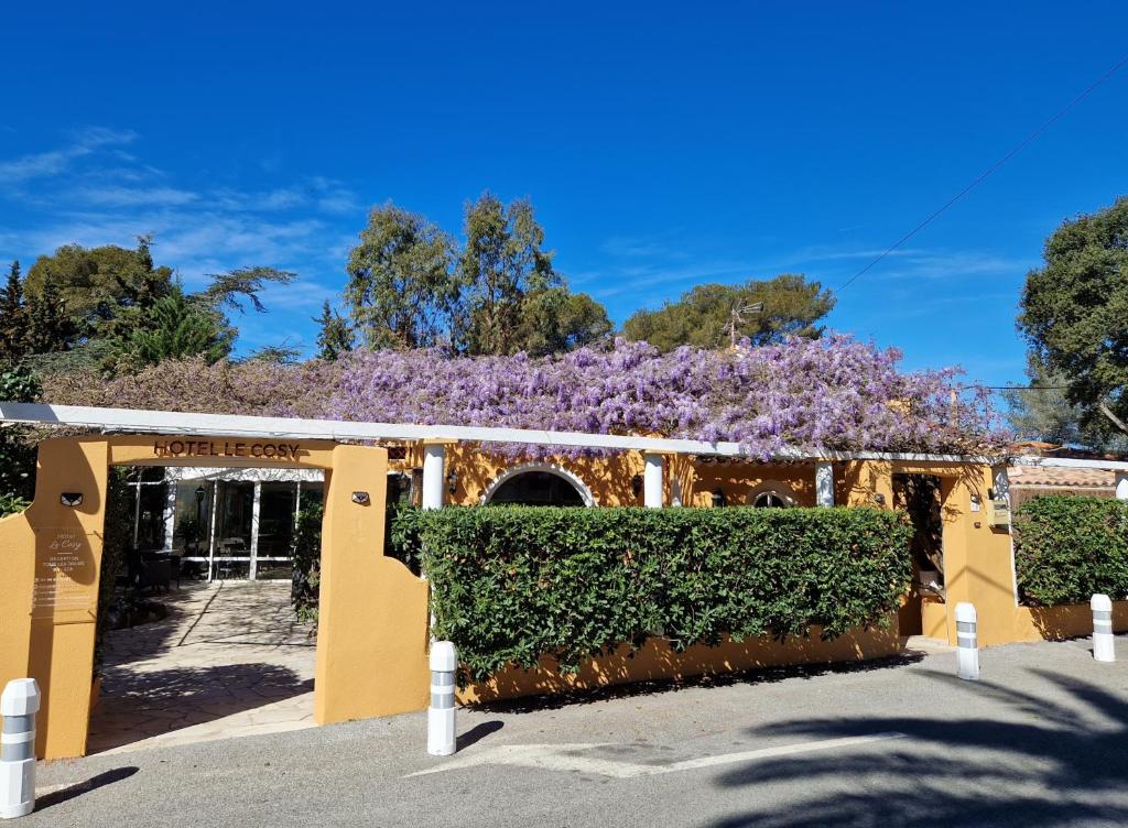 a building with purple flowers on top of it at Le Cosy in Saint-Aygulf