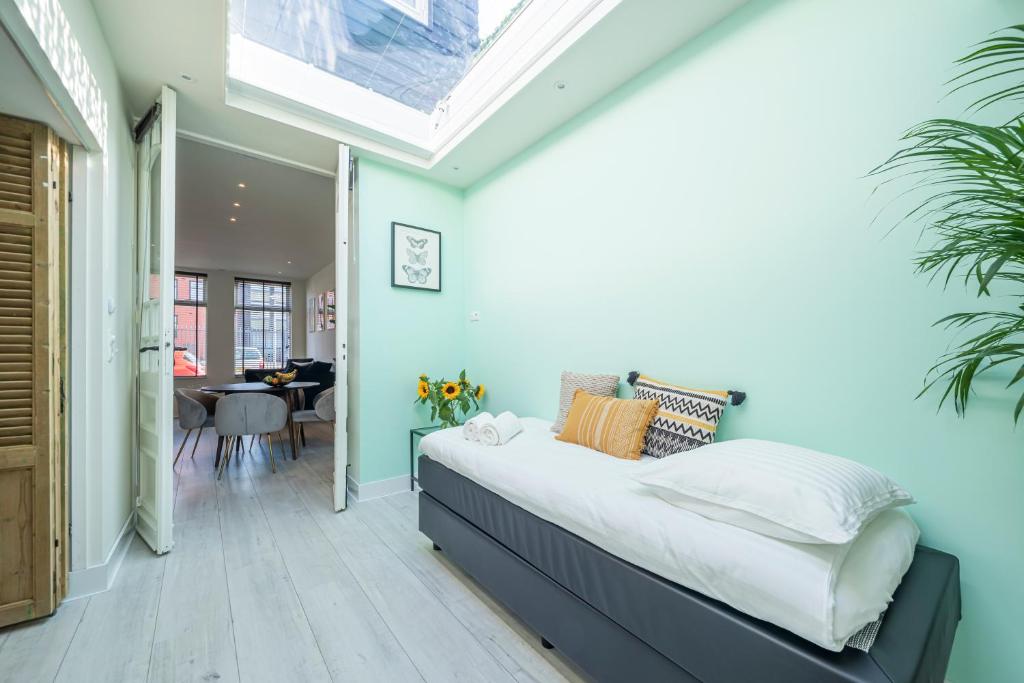 a bedroom with a large bed with a skylight at Luxury City Home Alkmaar nearby Amsterdam. in Alkmaar