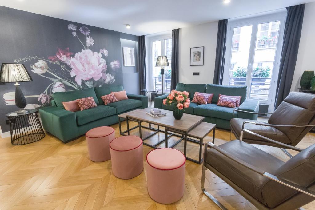 a living room with green couches and pink accents at My Showroom in Paris