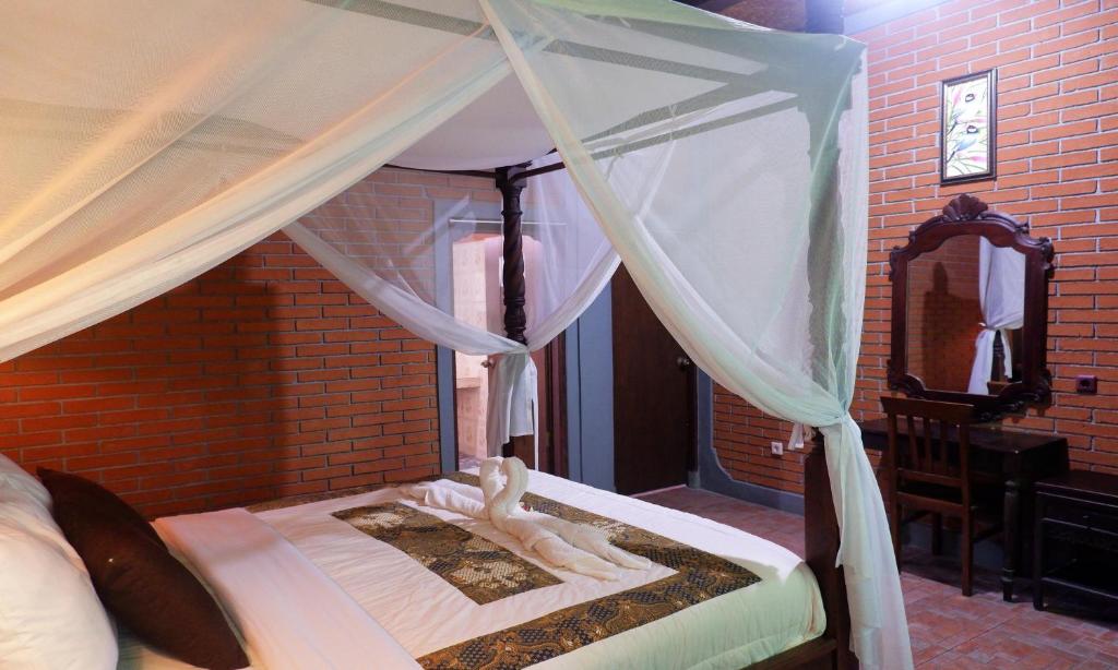Postel nebo postele na pokoji v ubytování Danasari Homestay
