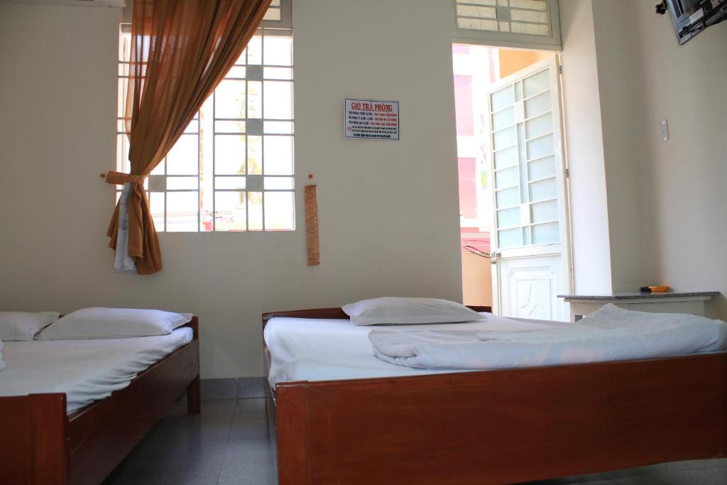 Postel nebo postele na pokoji v ubytování Ngoc Mai Guesthouse