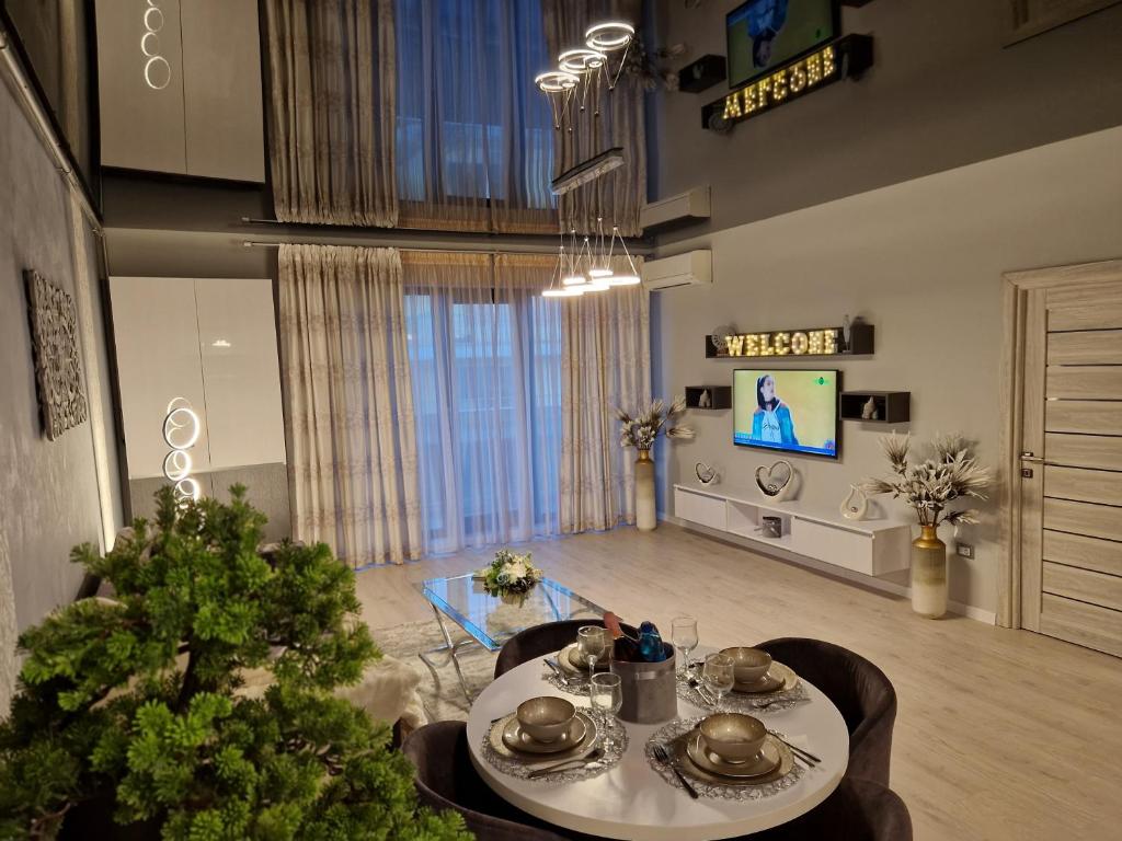 a living room with a table and a christmas tree at Alecsa 2 Luxury Residence in Mamaia