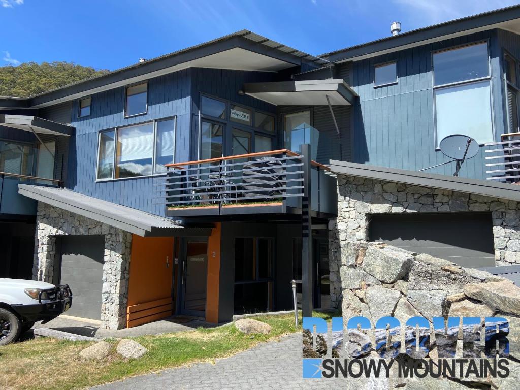 a large house with a car parked in front of it at Powder 2 in Thredbo