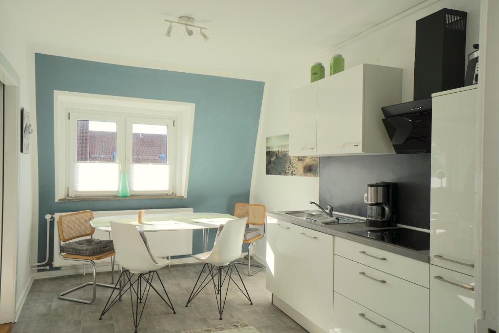uma cozinha com mesa e cadeiras num quarto em Ferienwohnung Ankerplatz am Schleswiger Dom em Schleswig