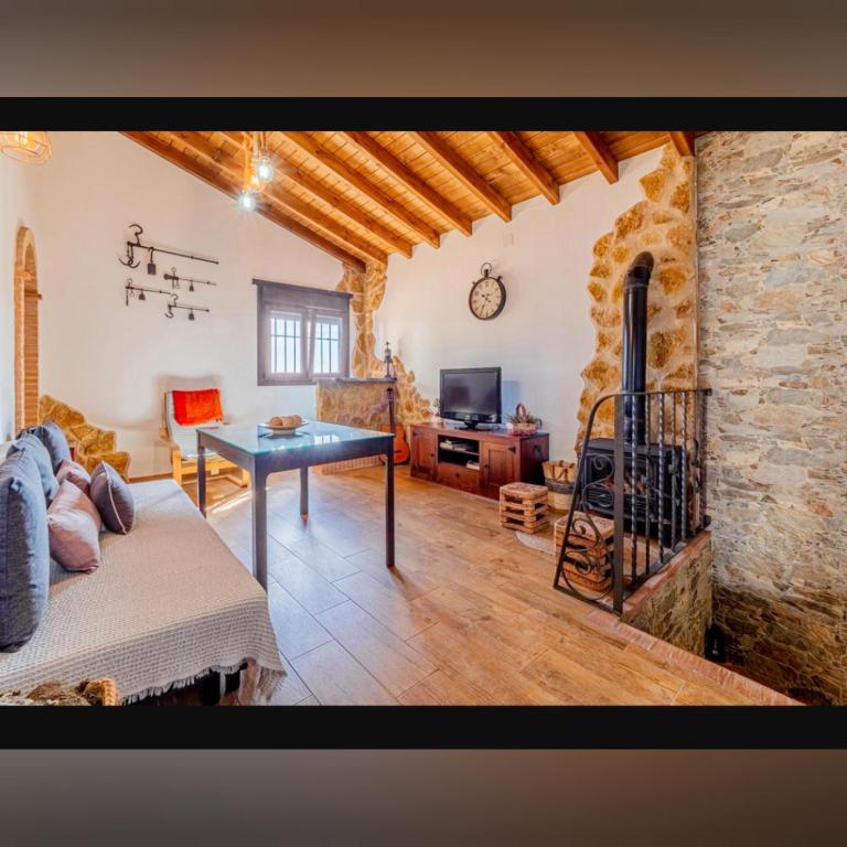 a living room with a couch and a fireplace at Fuente Vieja in Cortegana