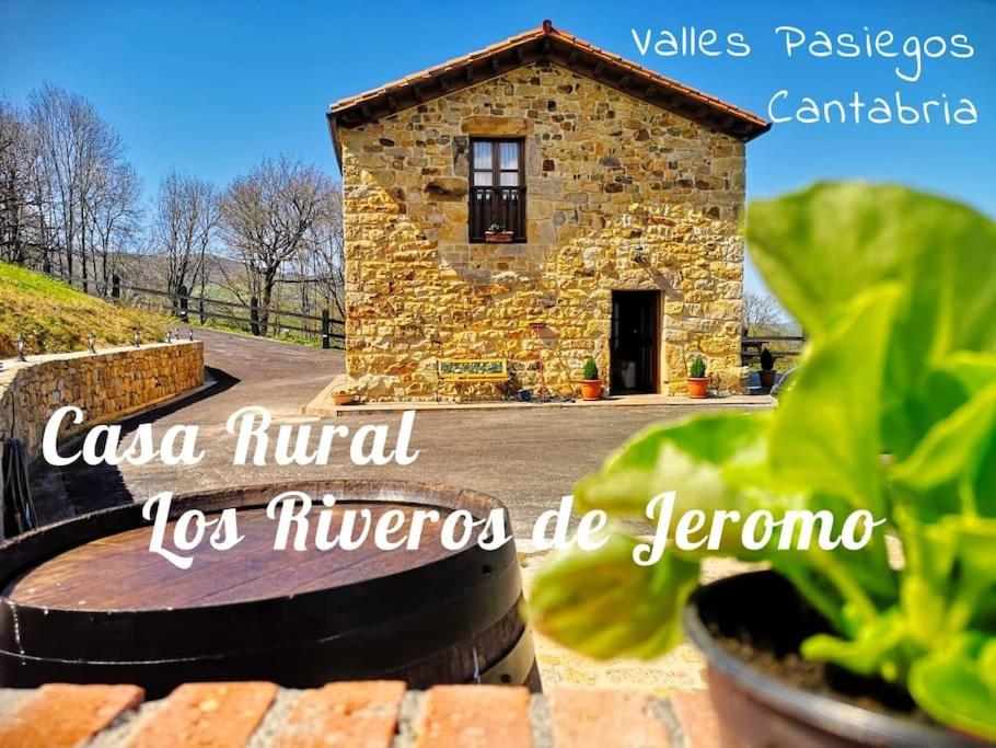 a stone house in the middle of a garden at Casa Rural Los Riveros de Jeromo in Selaya
