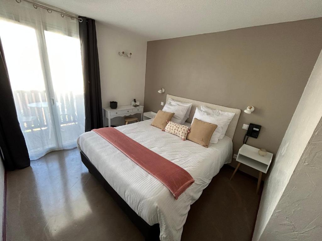Postel nebo postele na pokoji v ubytování Logis Hotel De La Clape