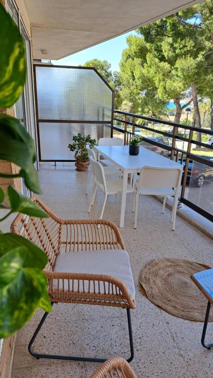 a patio with a table and chairs on a balcony at Colibri Apartment Beach in Salou