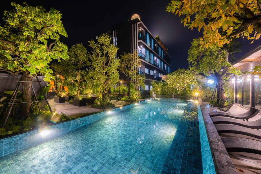 a swimming pool at night in a city at The View Chiang Dao Hotel in Chiang Dao