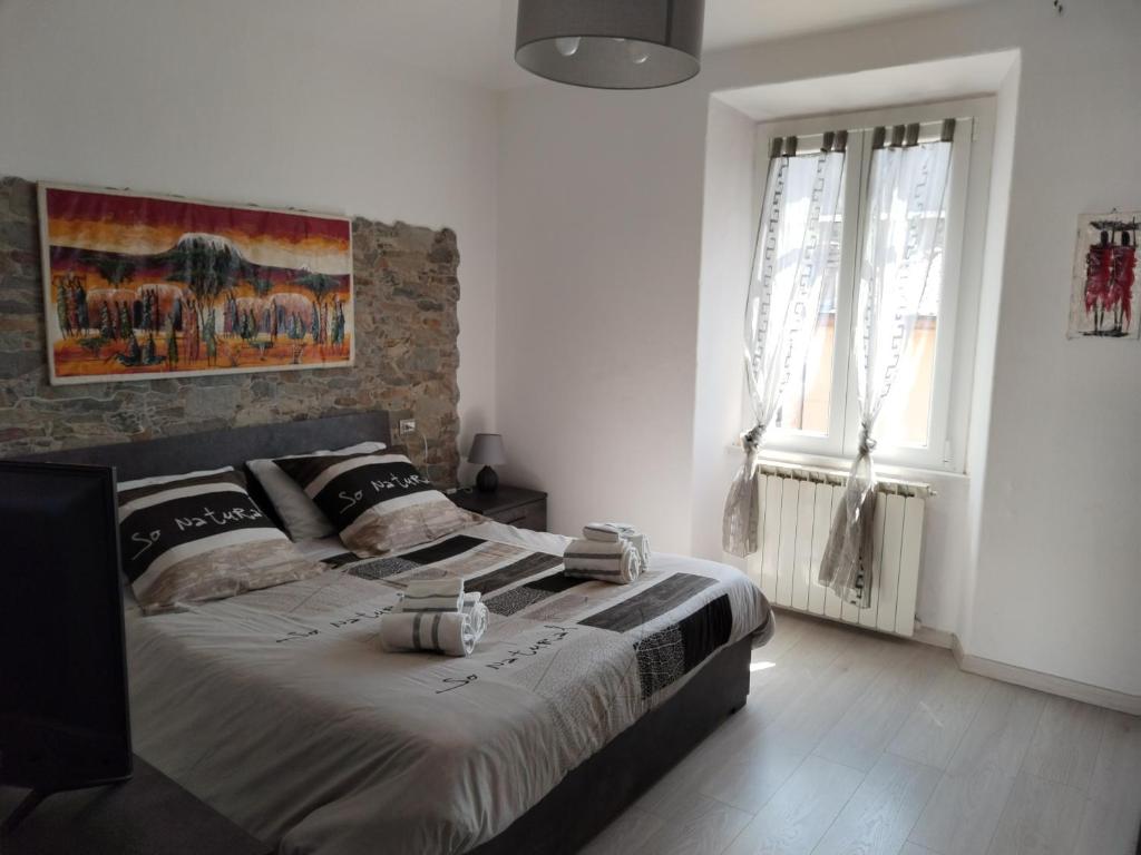 een slaapkamer met een bed en een schilderij aan de muur bij Casa Shanty in La Spezia