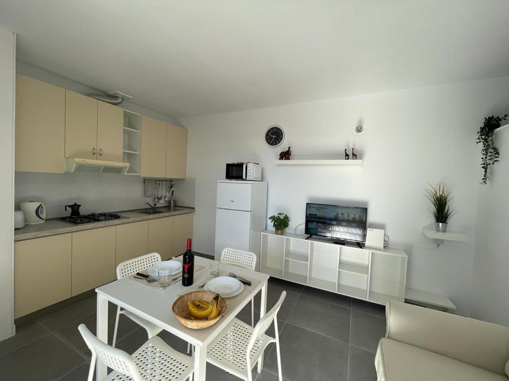 a kitchen with a white table and chairs and a table and chairsktop at Tenerife Primavera in Arona