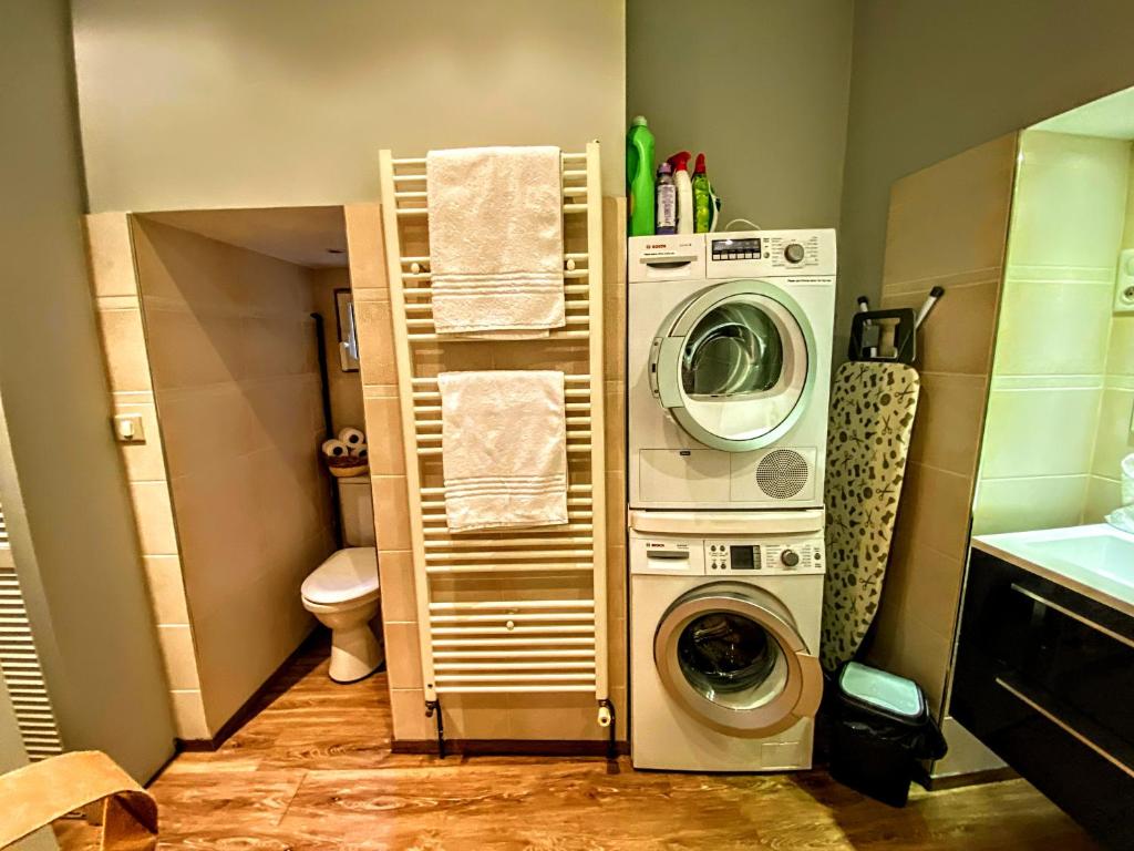 a bathroom with a washing machine and a washer at Centrally Located Sarlat Apartment with Medieval Town Views in Sarlat-la-Canéda