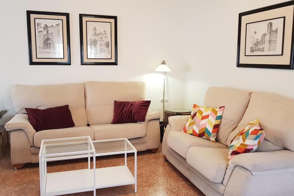 a living room with two couches and a table at Casa para vacaciones o estancias cortas in Barrio de las Cuevas