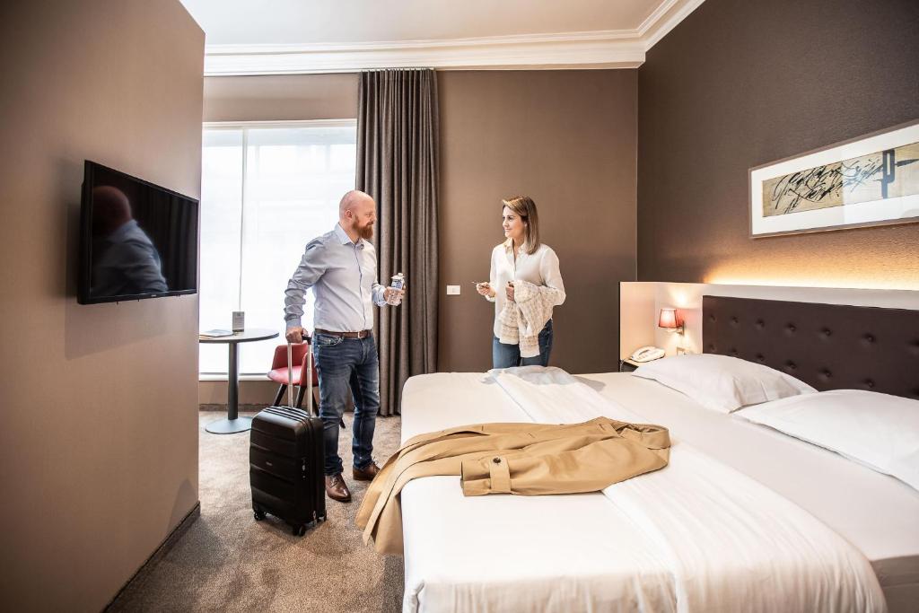 Postel nebo postele na pokoji v ubytování Hotel Navarra Brugge