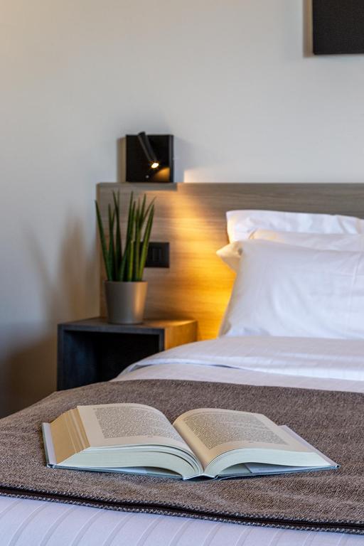 an open book sitting on top of a bed at Chiabot Langhe in Roddino