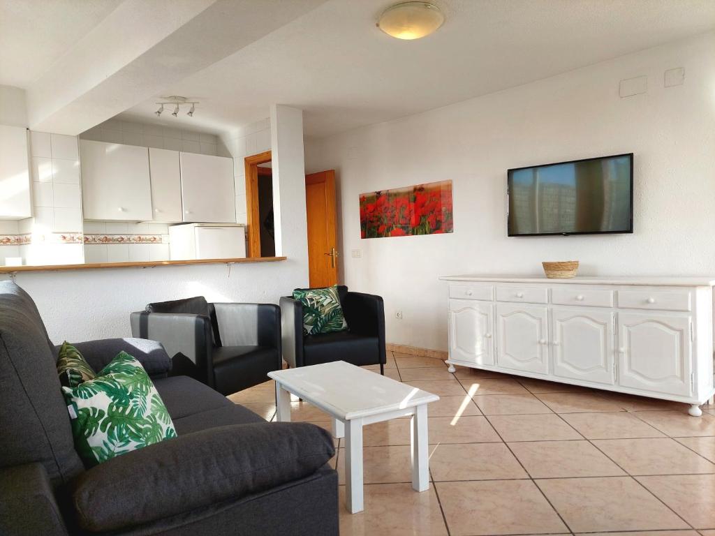 a living room with a couch and a table at Best View - Welcome Penthouse Apartamentos Karola in Benidorm