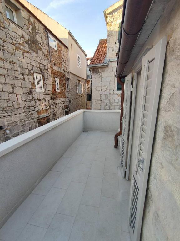 a balcony with a view of a building at The center of Split, renovated stone house in Split