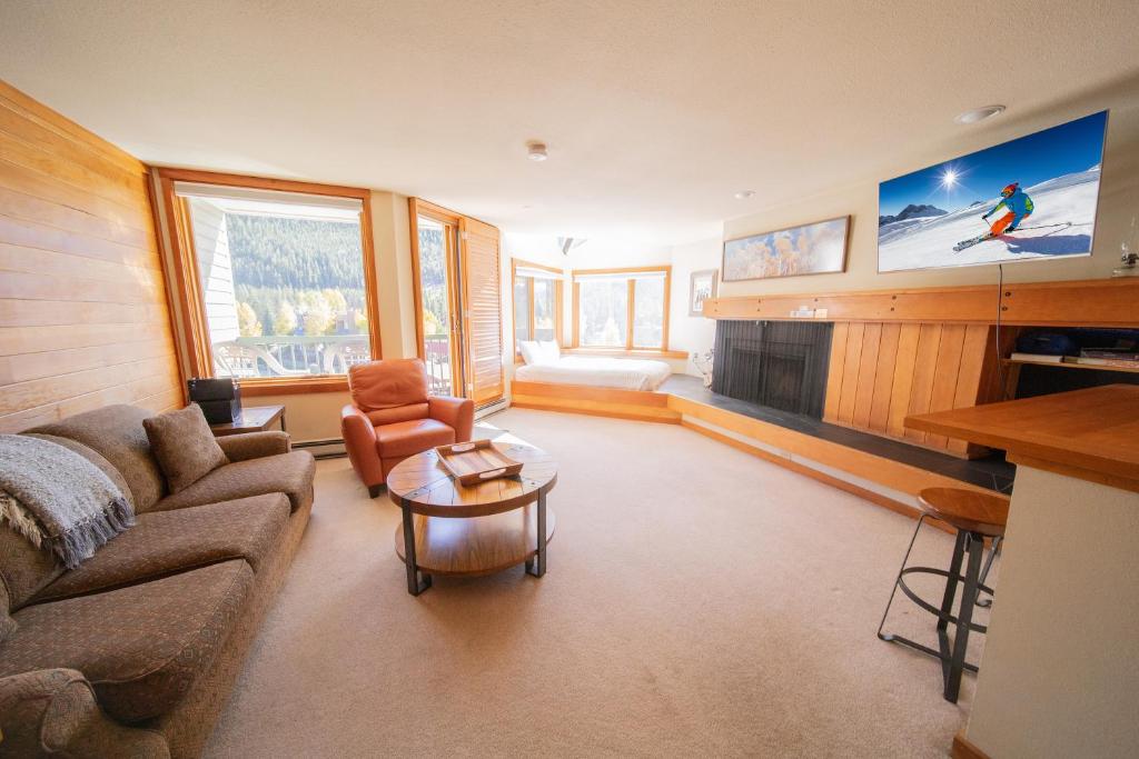 a living room with a couch and a tv at Lakeside 1495 in Keystone