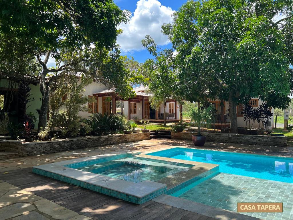 a swimming pool in front of a house at Casas Solar dos Pireneus in Pirenópolis