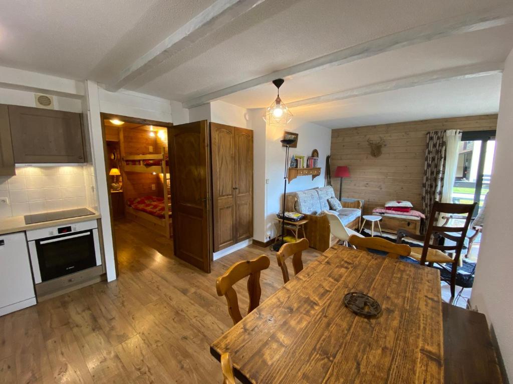 a kitchen and living room with a wooden table at Appartement Châtel, 2 pièces, 6 personnes - FR-1-693-32 in Châtel