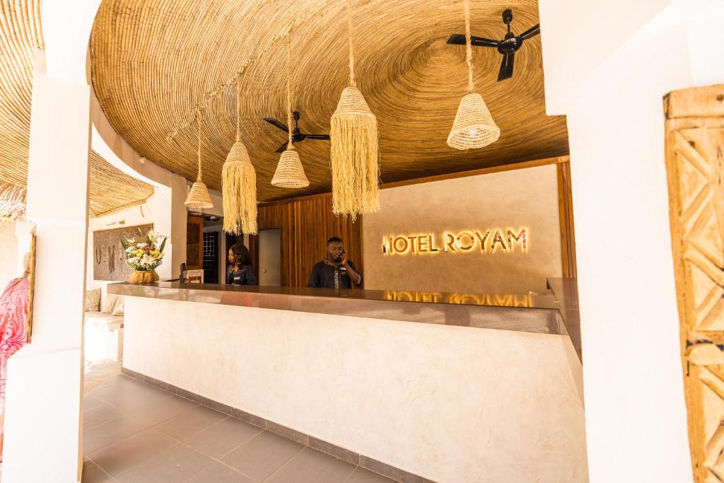 un hall d'un hôtel avec un comptoir de réception dans l'établissement Hotel Royam, à Saly Portudal