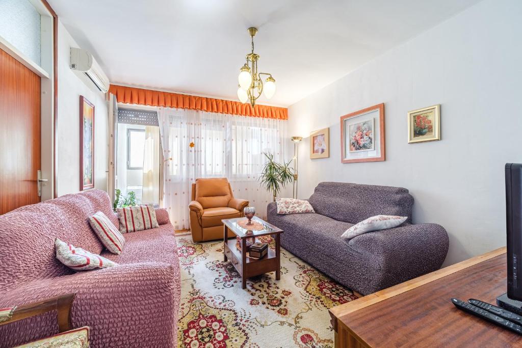 a living room with two couches and a tv at Apartment 123 for you in Split