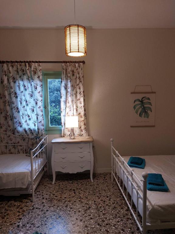 a bedroom with two twin beds and a window at Vitamin sea Studio in Panayía