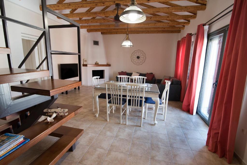 ein Wohnzimmer mit einem Tisch, Stühlen und einem Sofa in der Unterkunft Mare e Pietra in Monemvasia