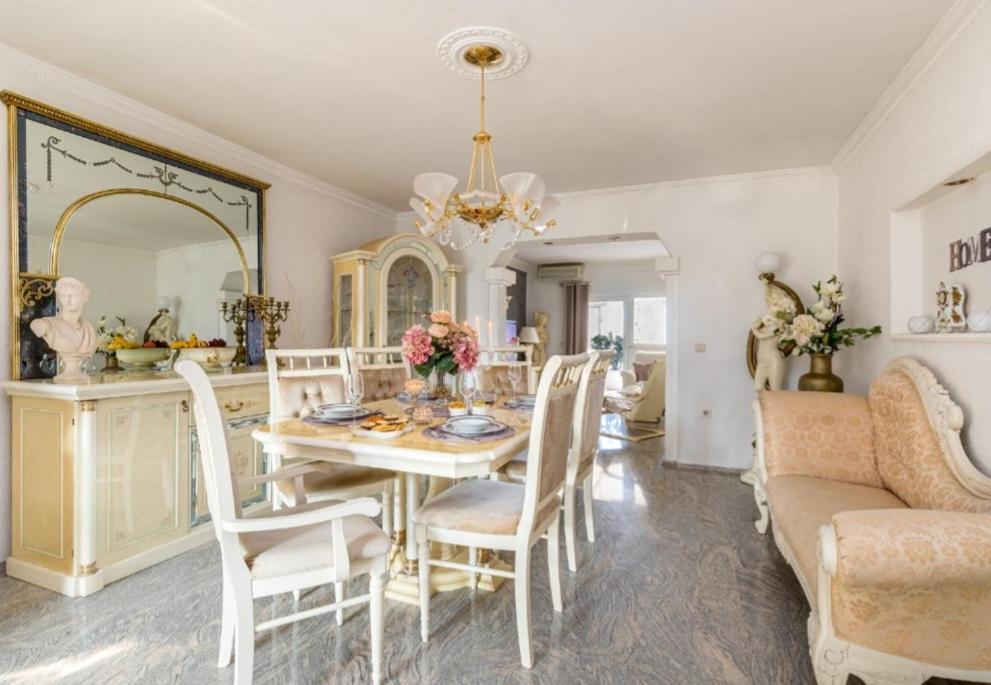 a dining room with a table and a mirror at Royal Apartments Sandra in Štinjan