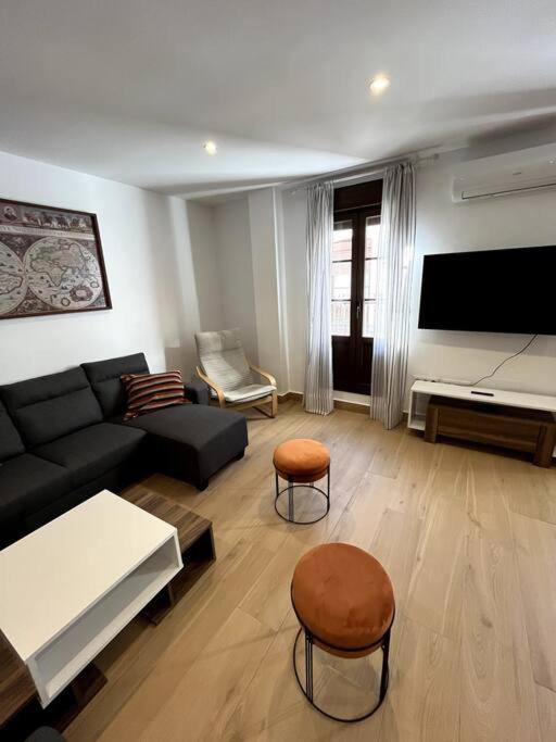 Televízia a/alebo spoločenská miestnosť v ubytovaní ANGELFLAT CENTRO